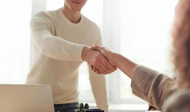 Shaking hands An financial adviser shaking hands with a client.