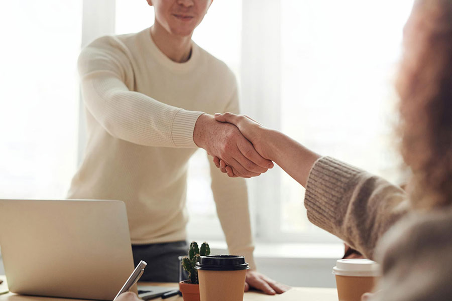 An financial adviser shaking hands with a client.